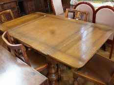 A modern oak extending dining table on turned supports, 150cm (when extended)