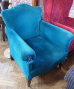 A 20th century armchair, in blue upholstery, on tapering supports and castors together with a