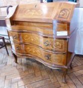 A reproduction walnut bureau, with inlaid decoration, fall-front enclosing an assortment of