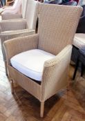 Three Lloyd Loom carvers, in cream, with cream cushions, with Lloyd loom plaques to back and a