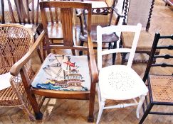 An oak open arm dining chair with sailing galleon woolwork tapestry panel seat on fluted supports,