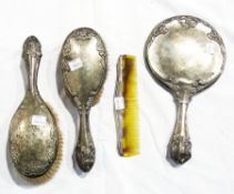 An Edwardian silver dressing table set, Chester 1906, relief-decorated with flowers, comprising of