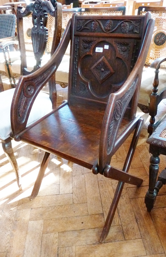 Reproduction Renaissance style carved hardwood open armchair, the panelled back with fruiting vine