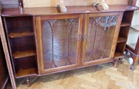 A reproduction mahogany display cabinet, the central panelled doors enclosing adjustable shelves,