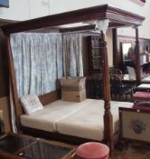 A mahogany framed full tester four-poster double bed, with reeded and lotus leaf carved columns,