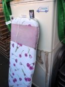 A Gorenje fridge/freezer and an ironing board