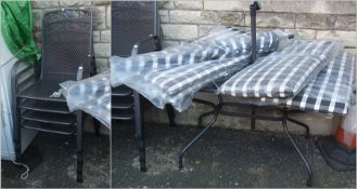 Metal garden table and four matching chairs with cushions and matching parasol