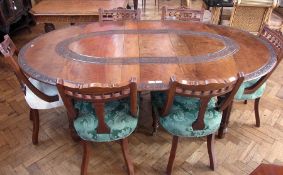 Early 20th century Indian hardwood dining table, oval carved with foliate and floral scroll bands