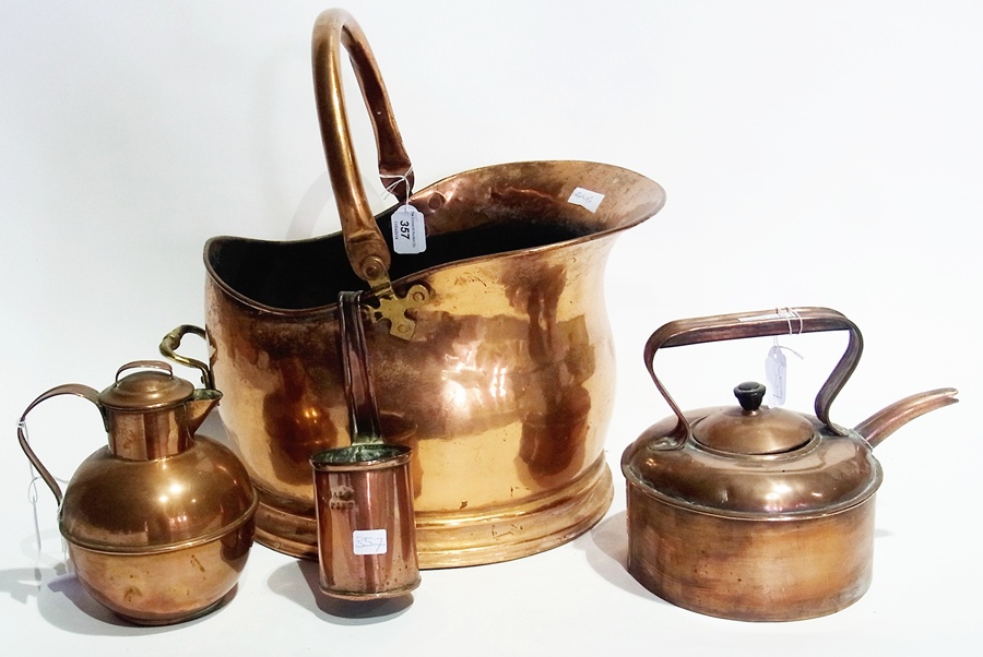 Old copper kettle, copper Jersey milk jug, copper cream ladle and a copper helmet-shaped coal