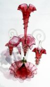 Victorian cranberry and clear glass epergne, having central flute with wavy everted rim, two similar