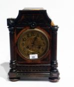 Edwardian stained wood mantel clock with 8-days movement, having  arch-surmount, turned finials,