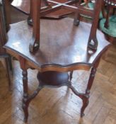 An Edwardian mahogany octagonal wavy top occasional table on turned reeded supports, united by