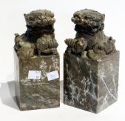 Pair oriental carved soapstone Buddhist lion bookends, each with paw resting on a dog, on square