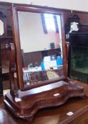 Victorian mahogany framed rectangular dressing table mirror, raised on scroll supports to serpentine