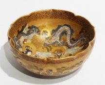 Satsuma pottery bowl, circular with serpentine rim, decorated and jewelled all over deities and