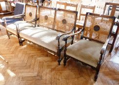 Early 20th century stained hardwood cane back open arm suite, viz:- two seater settee and pair