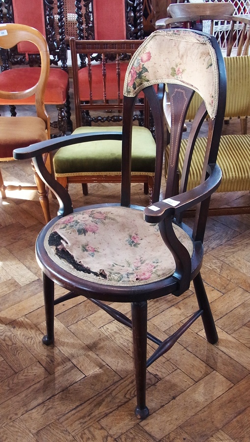 Early 20th century inlaid mahogany open arm chair, having shaped arch back with three curved