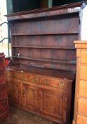 George III oak dresser, the raised platerack with ogee mould pediment, plain frieze fitted three