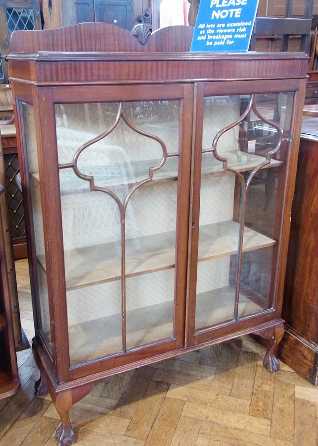 A glazed mahogany display cabinet, the pair of astragal glazed doors enclosing shelves, raised on