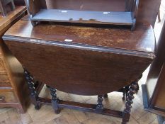 Twentieth century oak oval top gateleg table with turned spiral supports, united by stretchers,