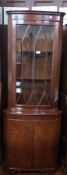 A reproduction mahogany bow-fronted astragal glazed corner cupboard, the astragal glazed door