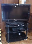 Toshiba LCD colour television, Sony DVD player on black glass and metal television stand