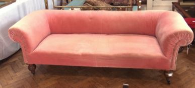 A long Chesterfield sofa, with studded pink upholstery, on turned legs with castors, 216cm long