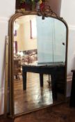 Large Victorian gold painted over-mantel mirror, the arched top with rope bow and tassel pediment,