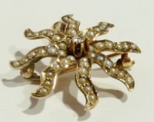 Gold, seedpearl and diamond pendant brooch in the form of a starfish, centred by tiny solitaire