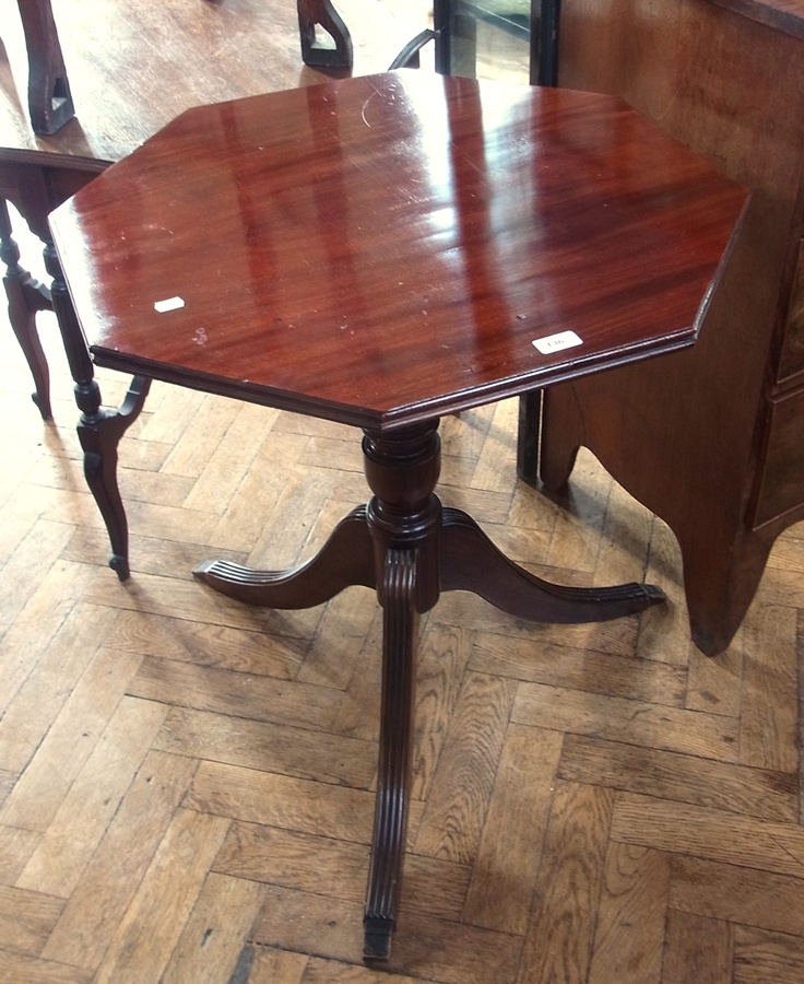 A mahogany octagonal top tripod table on turned column support, on reeded splayed legs, width 68cms