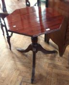 A mahogany octagonal top tripod table on turned column support, on reeded splayed legs, width 68cms