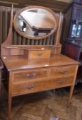 An Edwardian mahogany and satinwood mirror back dressing table, the oval bevelled mirror above a