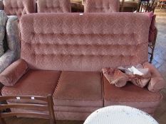 Parker Knoll four piece suite, viz:- three armchairs and three seater settee, upholstered in pink