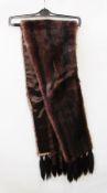 A dark mink stole with tails
