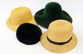 Two Panama hats, a felt beret and a green felt hat by Sandra Phillipps in a hat box