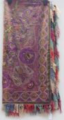 A large oriental style shawl, brown ground with purple embroidery decorated with figures