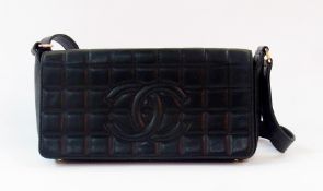 A Chanel "Baguette" shoulder bag with quilted and stitched logo, carrying Chanel authentication card