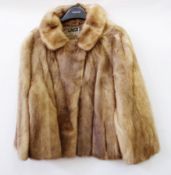 A short mink jacket with swing back