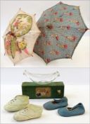 Baby bottle in box, two pairs of baby shoes, 1920's/30's children's parasols and a nursery apron (
