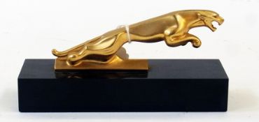 Gold coloured metal Jaguar car mascot, mounted on black rectangular plinth base, 13cm high