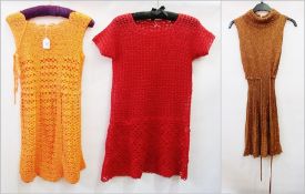 Two early 1970's crocheted mini dresses together with a "Sally Levison" gold knitted mini dress,