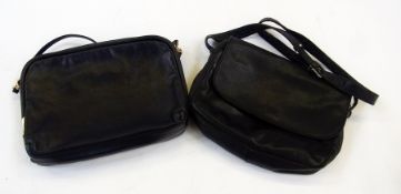 Two black leather Enny bags, one with a shoulder strap and fold-over flap, the other with a long