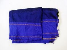 A piece of Indian purple sari silk with black tassels and gold border decoration