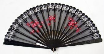 An ebony and black lace fan, handpainted pink flowers