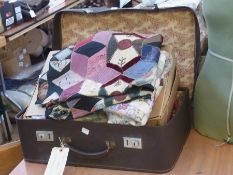 An unfinished patchwork quilt, another and assorted materials, etc. (1 suitcase)