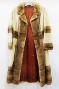 A vintage long rabbit fur coat with different coloured fur panels