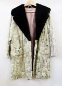 A white and black vintage fur coat possibly goat with a black beaver collar, labelled "C.H.R. Smith,