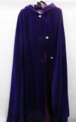 A purple velvet cloak with hood, with three large diamante buttons
