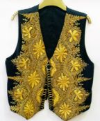 A heavily embroidered with gold thread black Turkish style waistcoat
