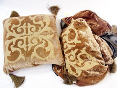 A pair bronze velvet pillows with foliate scroll decoration and tassels together with a matching